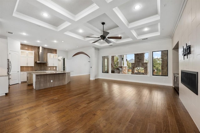 unfurnished living room featuring coffered ceiling, a fireplace, and dark wood-type flooring