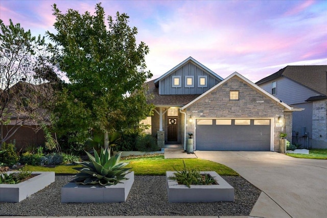 view of front facade featuring stone siding, board and batten siding, concrete driveway, and an attached garage