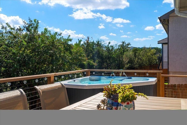 view of swimming pool featuring a wooden deck and a hot tub