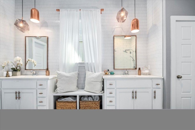 bathroom featuring a sink and two vanities