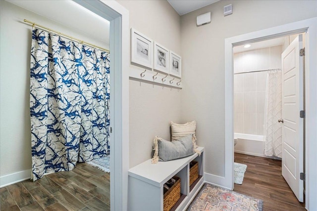 mudroom with wood finished floors and baseboards