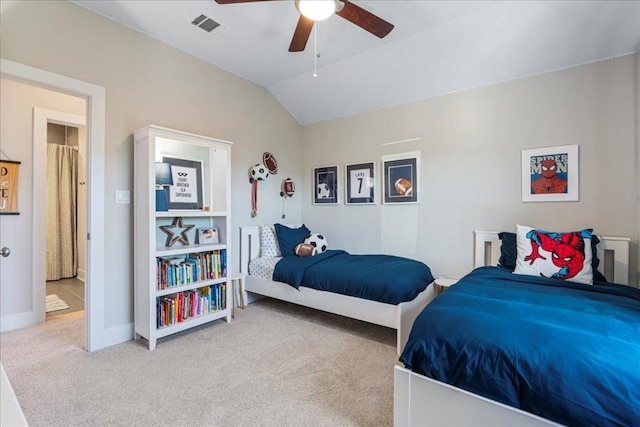 bedroom featuring visible vents, baseboards, lofted ceiling, carpet floors, and a ceiling fan