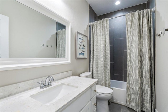 bathroom with tile patterned floors, shower / bath combo with shower curtain, toilet, and vanity