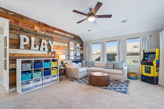 carpeted living room featuring visible vents, ceiling fan, and vaulted ceiling