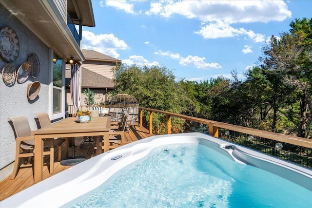 view of pool with outdoor dining area, a hot tub, and a wooden deck