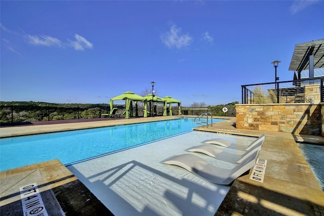 community pool with a patio area