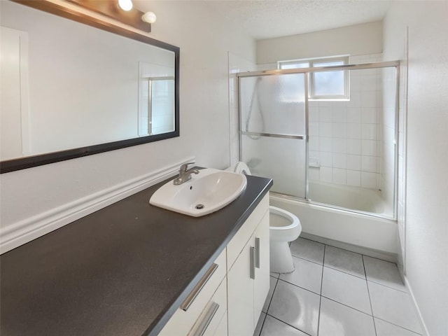 11510 Powder Mill Trl, Austin, TX 78750 - full bathroom with vanity, toilet, tile patterned floors, bath / shower combo with glass door, and a textured ceiling