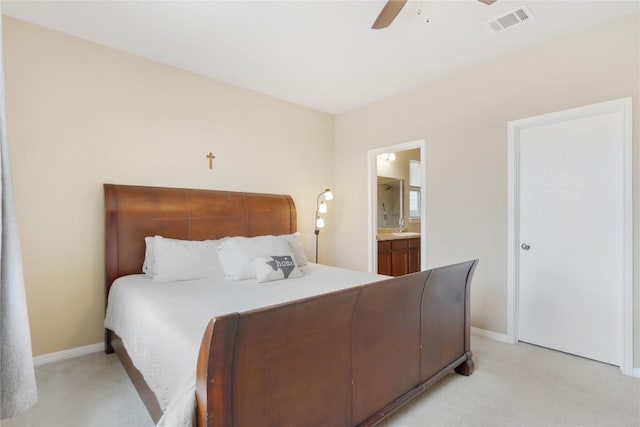 bedroom with a ceiling fan, visible vents, baseboards, ensuite bath, and light colored carpet