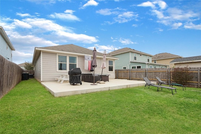 rear view of property with a lawn, a fenced backyard, and a patio area