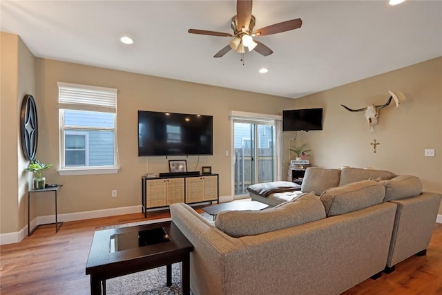 living room with a ceiling fan, recessed lighting, baseboards, and light wood finished floors