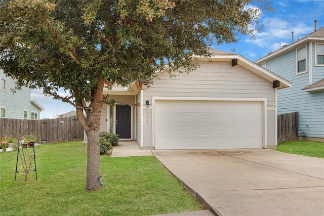 view of front facade with an attached garage, concrete driveway, a front yard, and fence