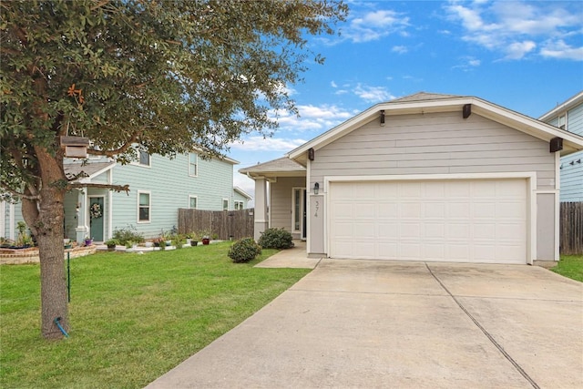 view of front of property with a front yard, fence, a garage, and driveway