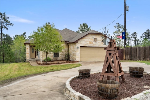 french country inspired facade featuring a front yard, fence, driveway, an attached garage, and a chimney