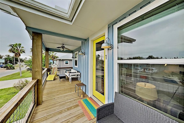 wooden terrace featuring a ceiling fan and covered porch