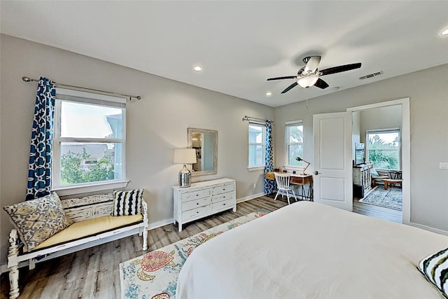 bedroom featuring visible vents, a ceiling fan, wood finished floors, recessed lighting, and baseboards