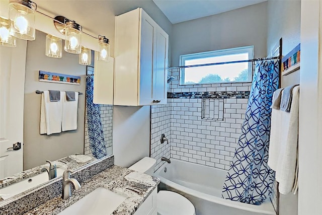 bathroom with vanity, shower / tub combo, and toilet