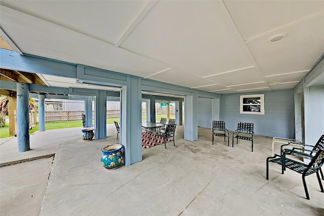 view of patio featuring outdoor dining area and fence