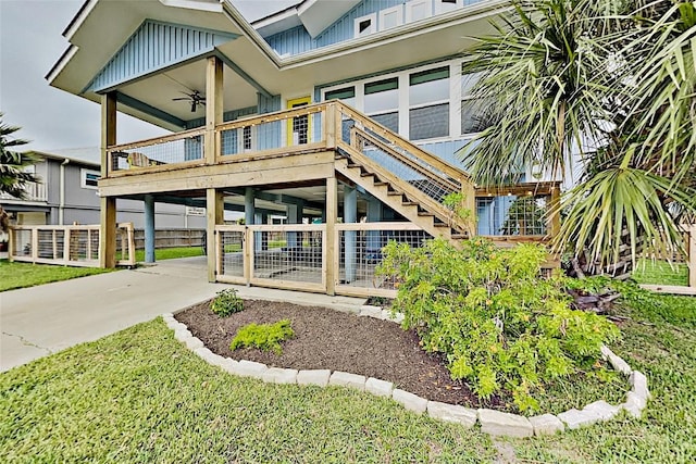 exterior space with board and batten siding, concrete driveway, and a ceiling fan