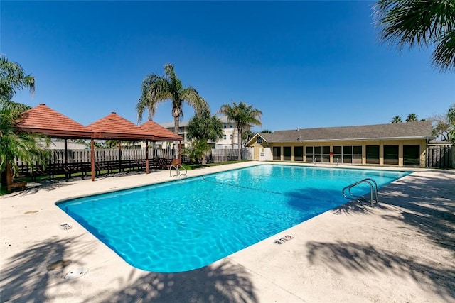 pool featuring a gazebo, a patio, and fence private yard