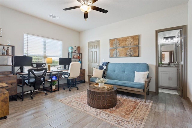 office area featuring wood finished floors, visible vents, and ceiling fan