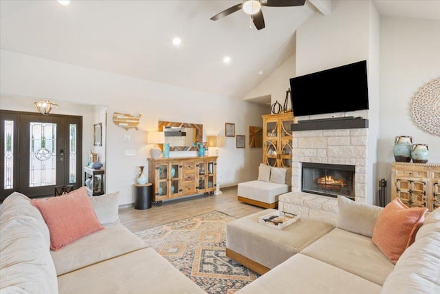 living area with ceiling fan, recessed lighting, a fireplace, wood finished floors, and high vaulted ceiling