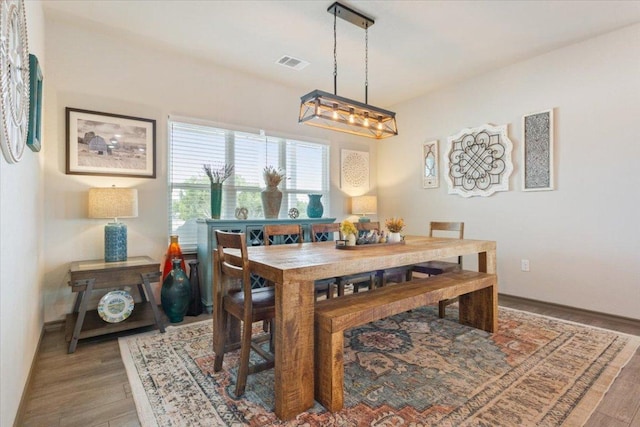 dining area with visible vents and light wood-type flooring