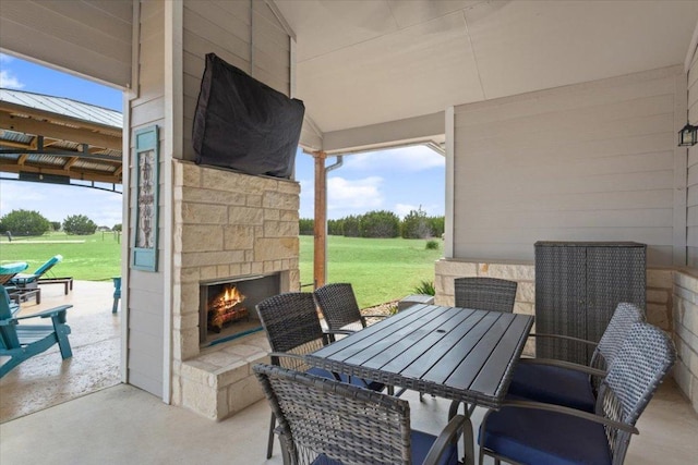 view of patio featuring an outdoor stone fireplace and outdoor dining space