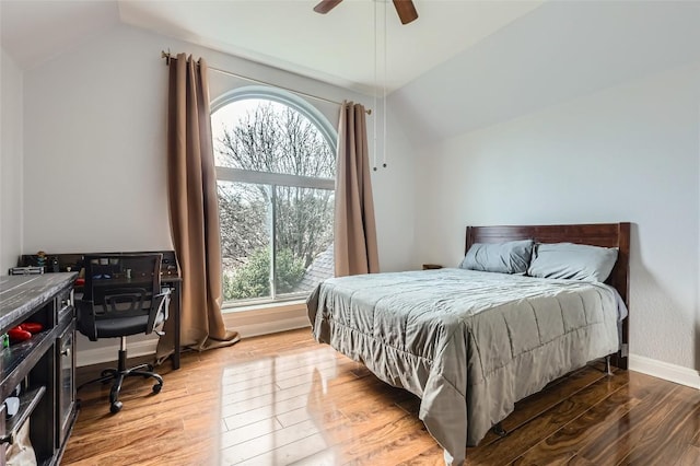 4514 Harvey Penick Dr, Round Rock, TX 78664 - bedroom with lofted ceiling, multiple windows, wood finished floors, and a ceiling fan
