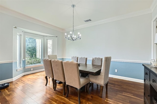 4514 Harvey Penick Dr, Round Rock, TX 78664 - dining area featuring a chandelier, wood-type flooring, and crown molding
