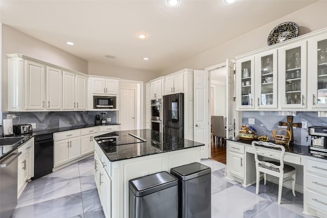 kitchen featuring white cabinetry, marble finish floor, tasteful backsplash, and black appliances