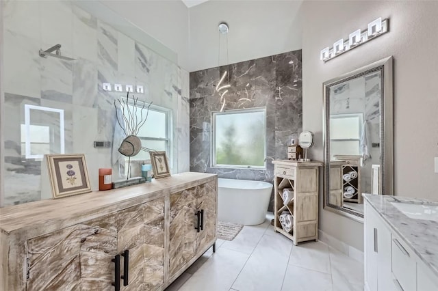 4514 Harvey Penick Dr, Round Rock, TX 78664 - full bath with vanity, a freestanding tub, tile patterned floors, and tile walls
