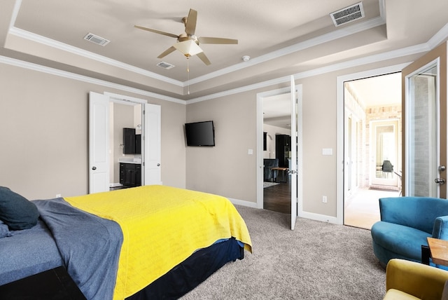 397 Arapaho Dr, Kyle, TX 78640 - bedroom with visible vents, crown molding, carpet, and a tray ceiling