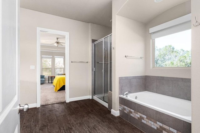 397 Arapaho Dr, Kyle, TX 78640 - bathroom with a garden tub, a stall shower, ensuite bathroom, wood finished floors, and baseboards