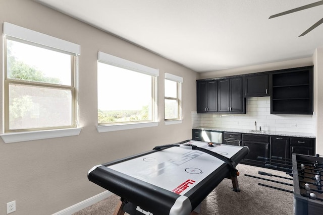 397 Arapaho Dr, Kyle, TX 78640 - game room with a sink, baseboards, carpet, and a ceiling fan