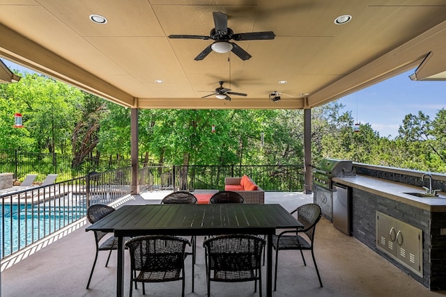 397 Arapaho Dr, Kyle, TX 78640 - view of patio / terrace with fence, outdoor dining space, area for grilling, an outdoor kitchen, and a sink