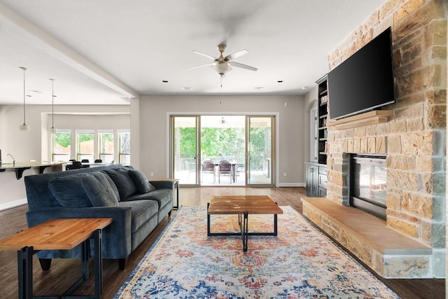 397 Arapaho Dr, Kyle, TX 78640 - living area with visible vents, baseboards, wood finished floors, and a fireplace