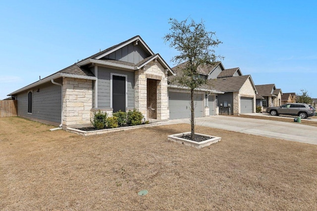 view of front of property with a front lawn, stone siding, board and batten siding, concrete driveway, and a garage