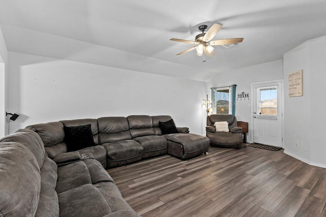 living room featuring ceiling fan, wood finished floors, and vaulted ceiling