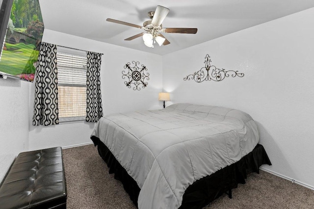 carpeted bedroom featuring baseboards and a ceiling fan