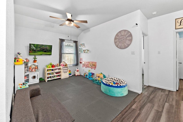 rec room featuring lofted ceiling, wood finished floors, baseboards, and ceiling fan