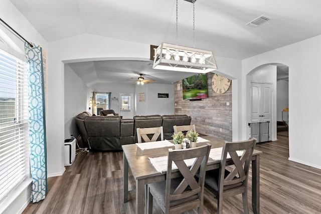 dining area with visible vents, ceiling fan, lofted ceiling, dark wood-style floors, and arched walkways