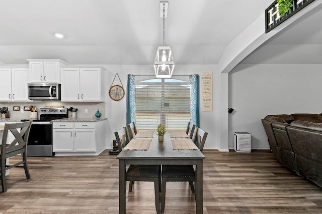 dining space featuring wood finished floors and baseboards