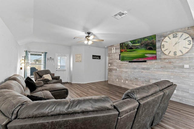 living room featuring visible vents, wood finished floors, and a ceiling fan