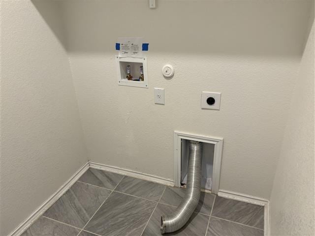 clothes washing area featuring hookup for a gas dryer, baseboards, hookup for an electric dryer, hookup for a washing machine, and laundry area