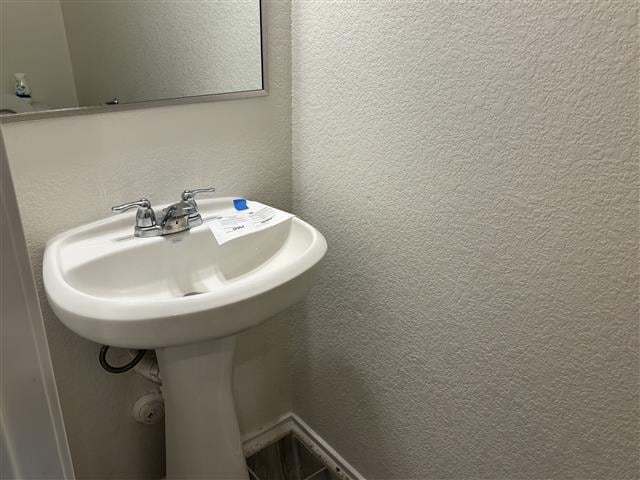 bathroom with a textured wall