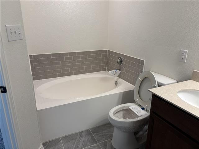 bathroom featuring a bath, toilet, and vanity