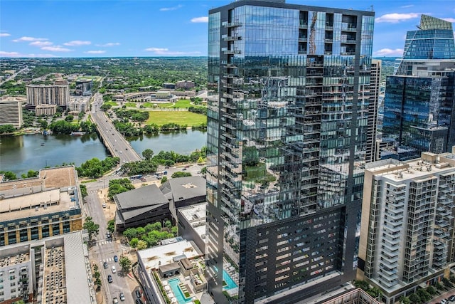 birds eye view of property with a water view and a city view