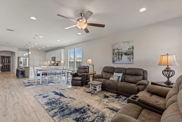 living area with recessed lighting, visible vents, and light wood-style flooring