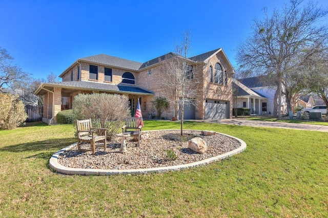 traditional-style house with brick siding, an attached garage, driveway, and a front yard