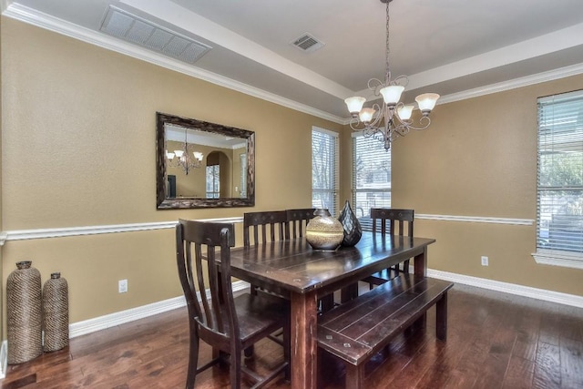 dining space featuring baseboards, wood finished floors, visible vents, and a chandelier